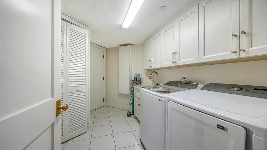 Even a separate laundry room with new washer/dryer a sink great cabinetry a separate private service entrance  Truly lives like a home !