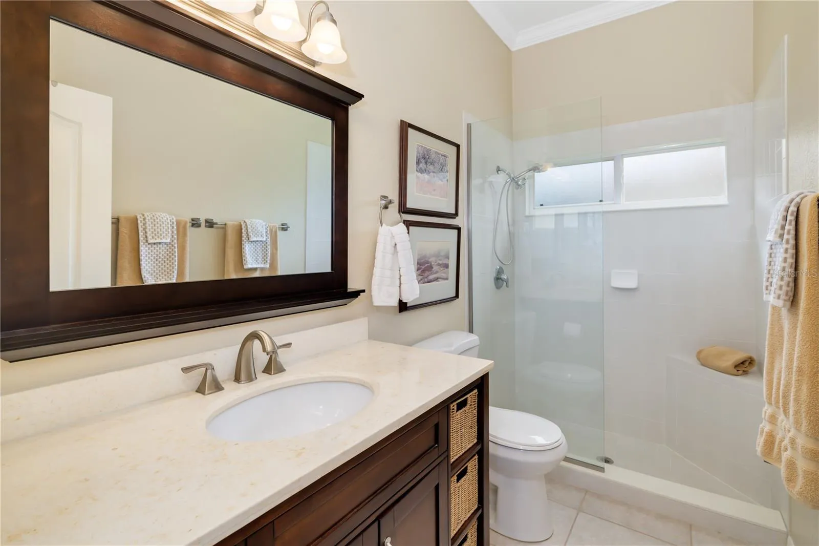 Bathroom 2, shared between bedroom 2, 3, 4 with stone countertops, walk in shower, linen closet