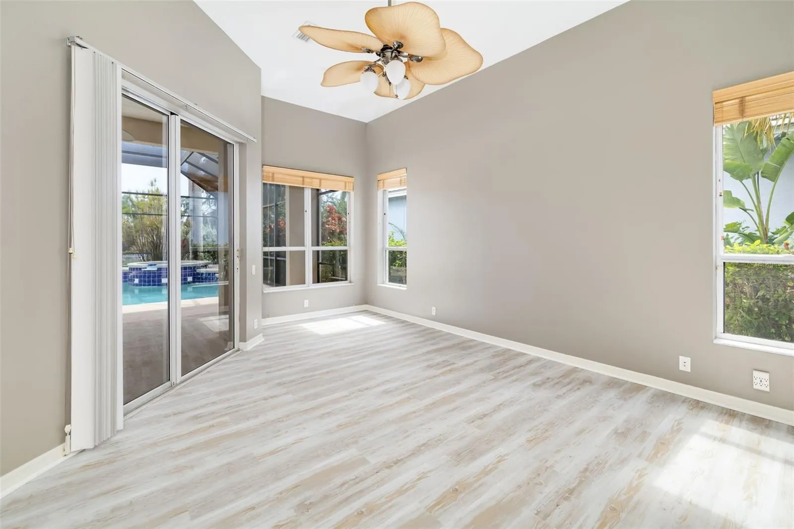 Private primary bedroom, with sliding doors leading out to the lanai and pool/spa, view of the canal and boat dock.