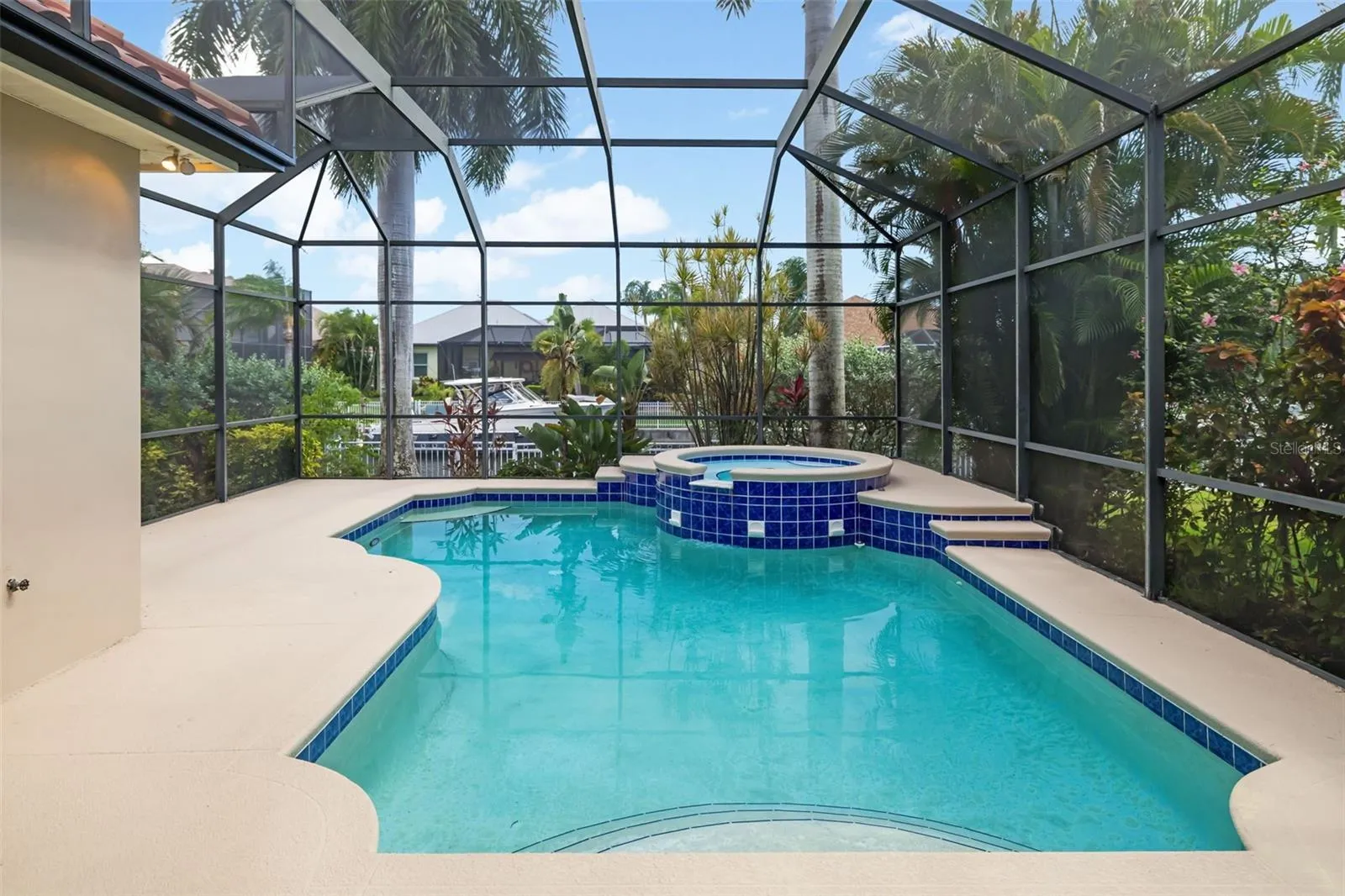 Private tranquil pool, with spa, space for entertaining guests, steps to your own boat dock and canal in your backyard