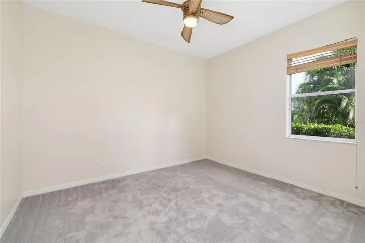 Bedroom 3 with large closet and view of the backyard and boat dock