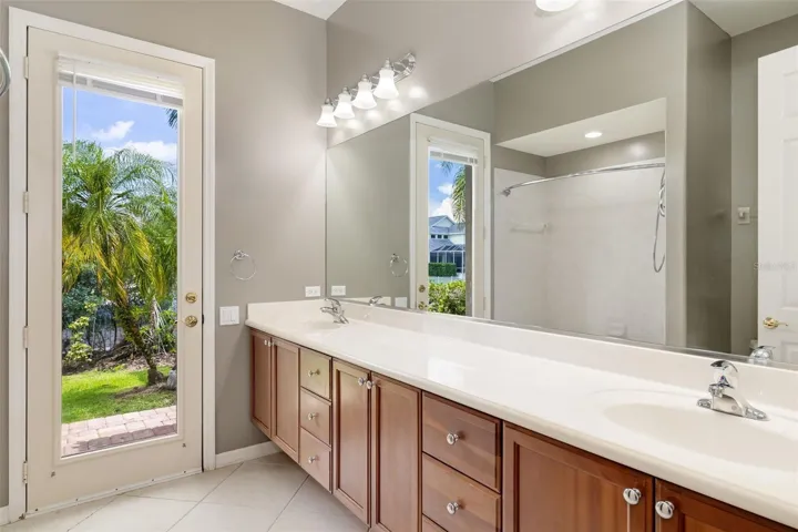 Second bathroom shared between bedroom 2 and 3, access to outdoor backyard, dock and lanai/pool.