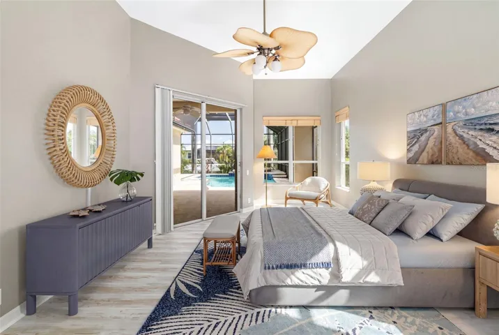 Primary, bedroom, sitting area, private access to lanai with water view overlooking the pool/spa.