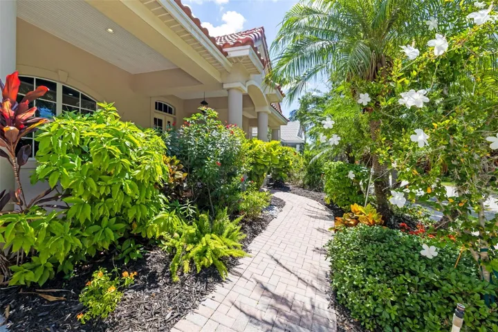 Lush tropical Florida Landscaping, creating a serene tranquil inviting private residence at Harbour Walk at The Inlets