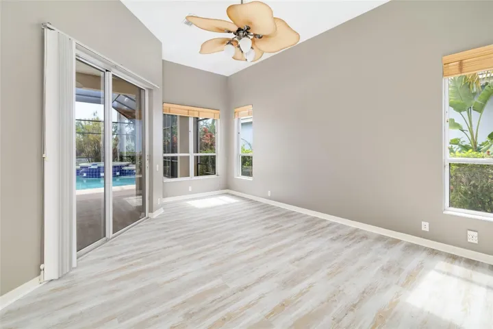 Private primary bedroom, with sliding doors leading out to the lanai and pool/spa, view of the canal and boat dock.