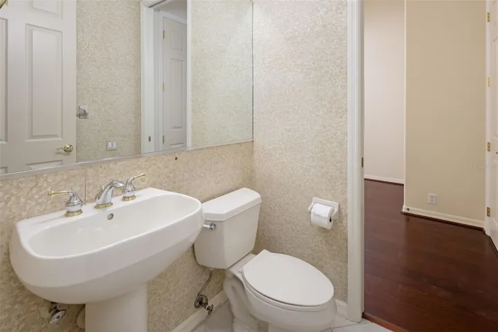 Den/office half bath with pedal stool sink.
