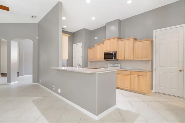 Open kitchen with wood cabinetry