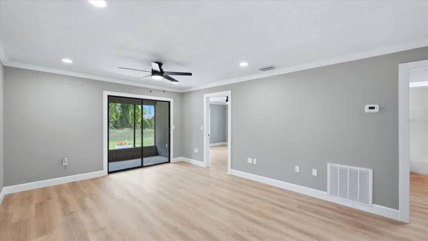 living room looking out to rear patio and bedroom