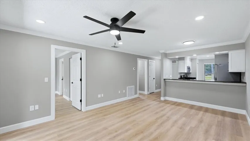 Living room looking into bedroom, hallway, and kitchen