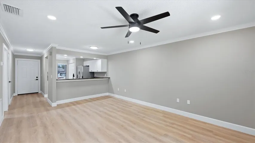 living room looking into dining room front entry and kitchen