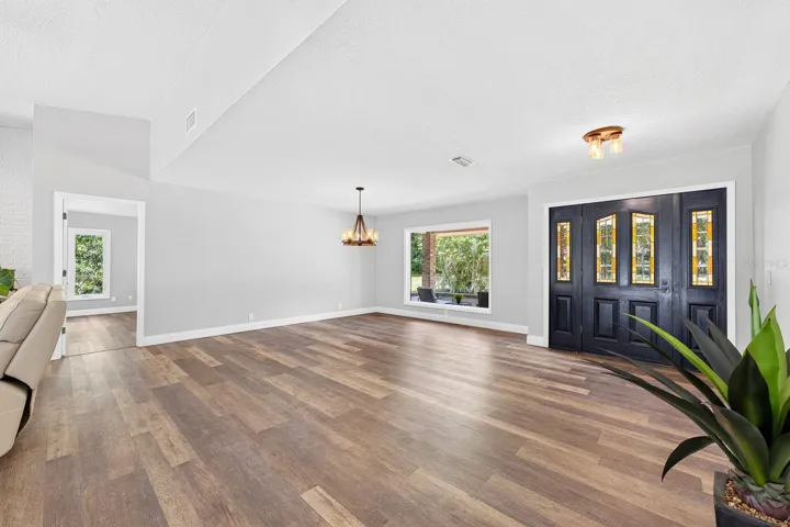 Open living and dining, foyer/front entry.
