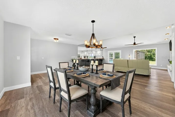 Open concept main living has a seamless flow from the dining area into the living area and the kitchen beyond. Virtually Staged.