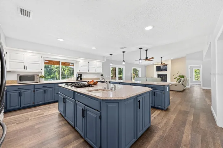 The large center island features a gas cooktop.
