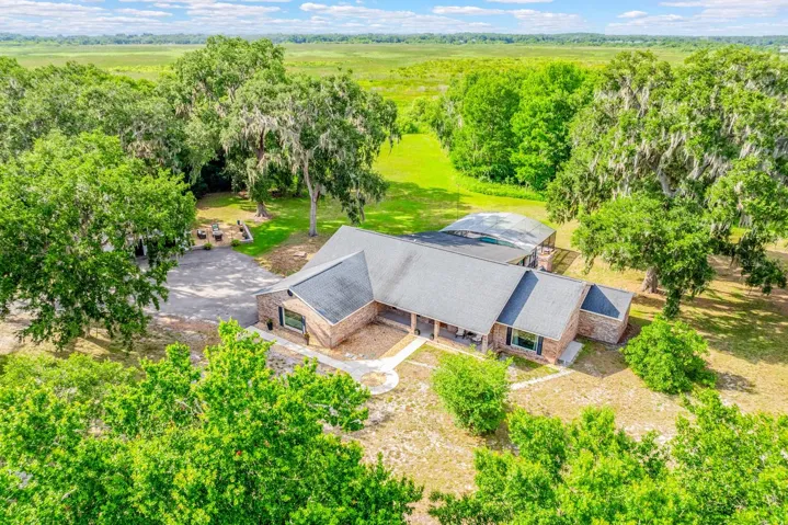 Peaceful, private, and packed with possibilities, this beautifully updated POOL HOME sits on TWO PARCELS totaling 5 ACRES with a PRIVATE GATED ENTRANCE, a 3/4 ACRE POND WITH DOCK, and beautiful views of Lake Runnymede!
