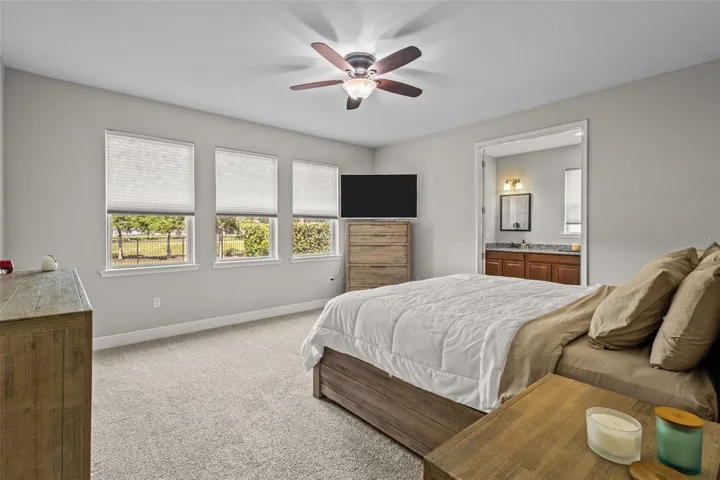 Primary bedroom with peaceful pond-view backdrop