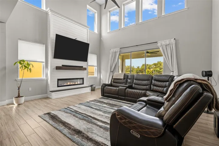 Bright two-story living room with custom fireplace