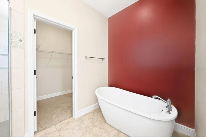 Primary en-suite bath features a separate soaking tub.