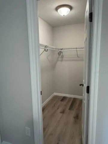 Model home owner's suite walk-in closet