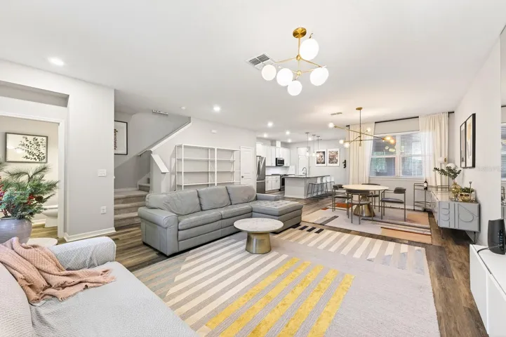 LUXURY VINYL PLANK FLOORING flows throughout the main living areas, while the spacious Living Room, Dining area, and Kitchen seamlessly connect to create a bright and inviting atmosphere.
