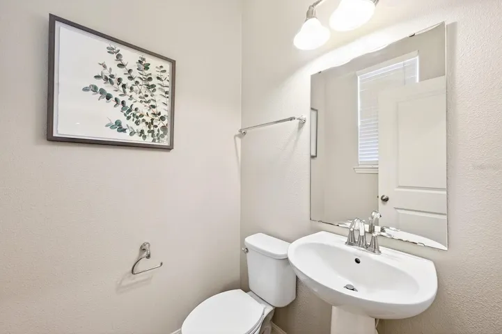 A convenient half bath and Laundry Room complete the first floor.