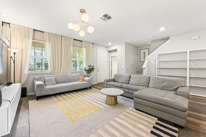 The generously-sized Living Room is filled with natural light from the large front windows.