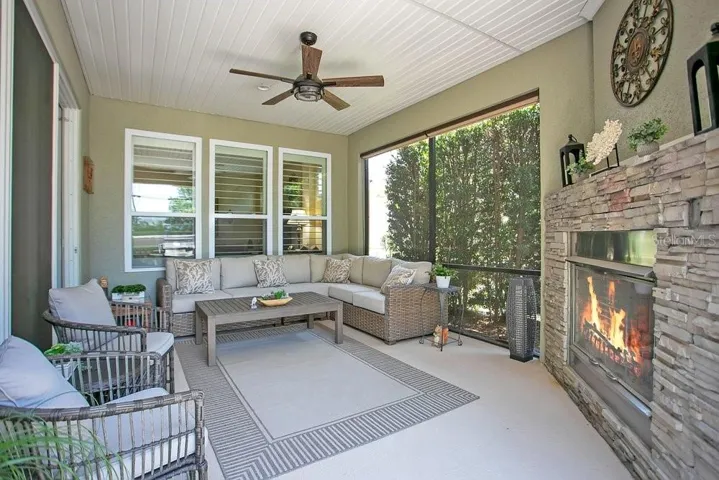Back Porch lanai with gas fireplace to the right