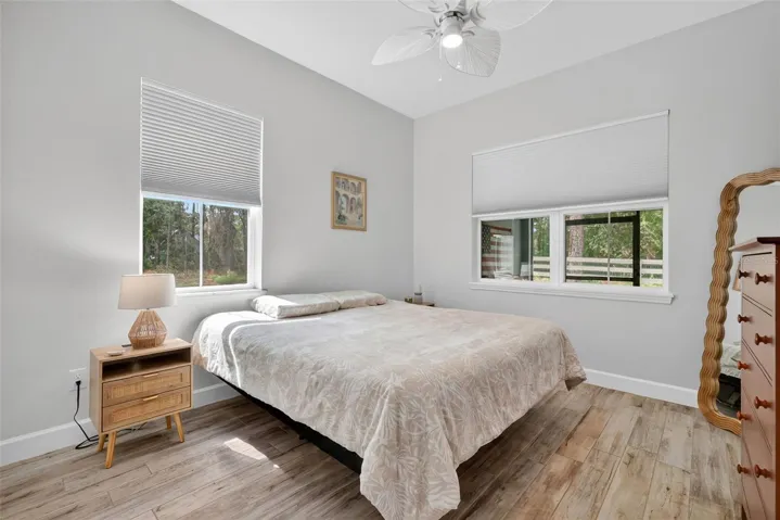 Guest bedroom with serene wooded backdrop