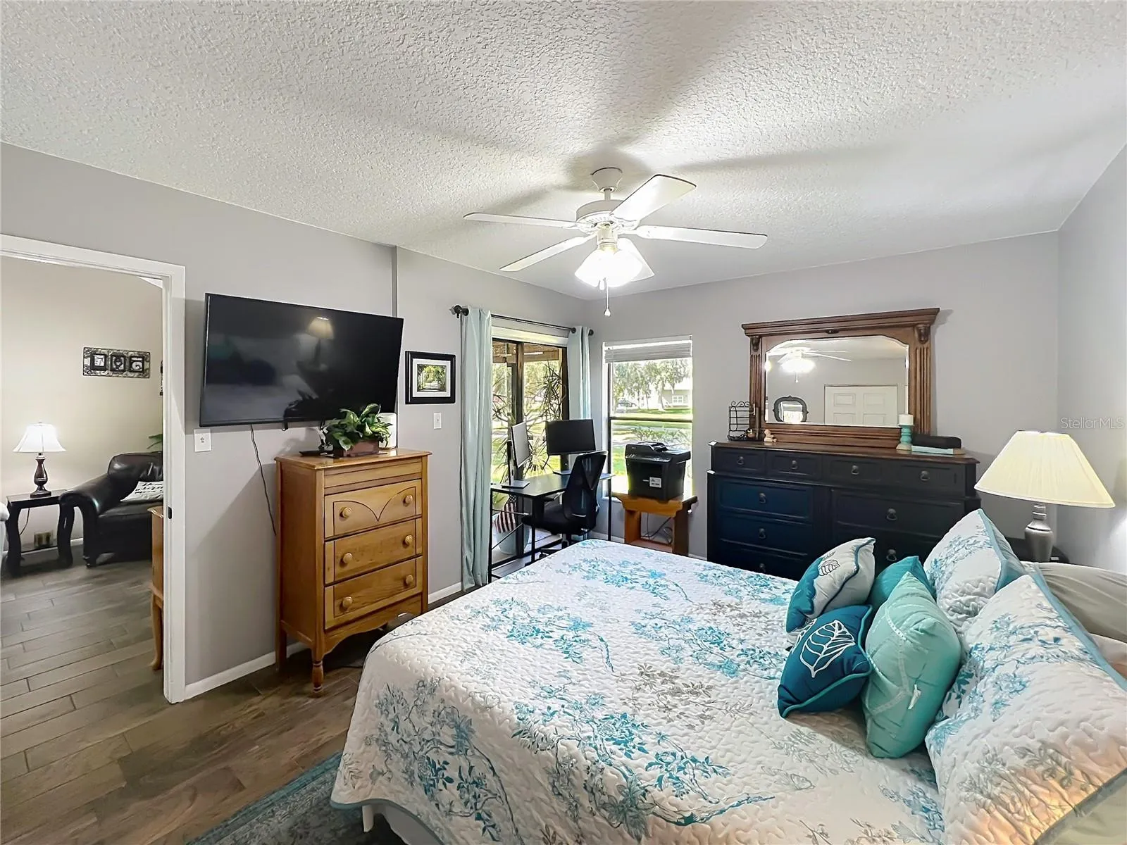 Primary Bedroom with Sliding Glass Doors to Screened-In Patio