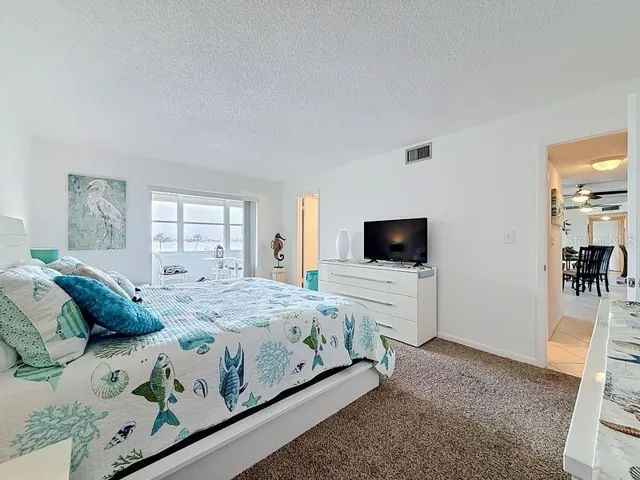 Peaceful Primary Suite with an abundance of natural light, soothing coastal tones, and space to unwind after a long day