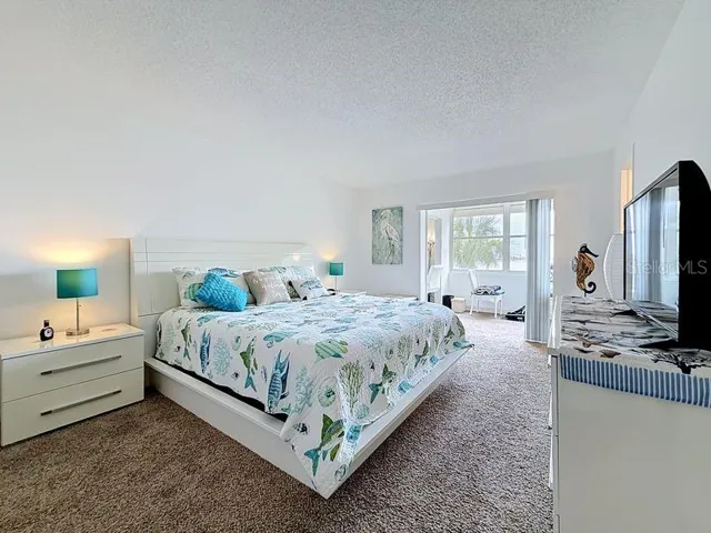 Peaceful Primary Suite with an abundance of natural light, soothing coastal tones, and space to unwind after a long day