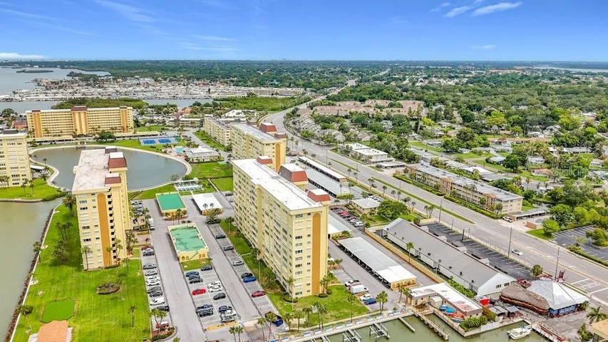 Resort-style community view featuring the Washington building, tennis and pickleball courts, and sparkling pool- all nestled around the tranquil bayou