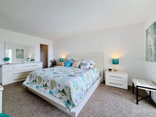 Peaceful Primary Suite with an abundance of natural light, soothing coastal tones, and space to unwind after a long day