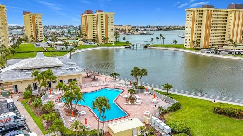 Resort-style community view featuring the Washington building, tennis and pickleball courts, and sparkling pool- all nestled around the tranquil bayou