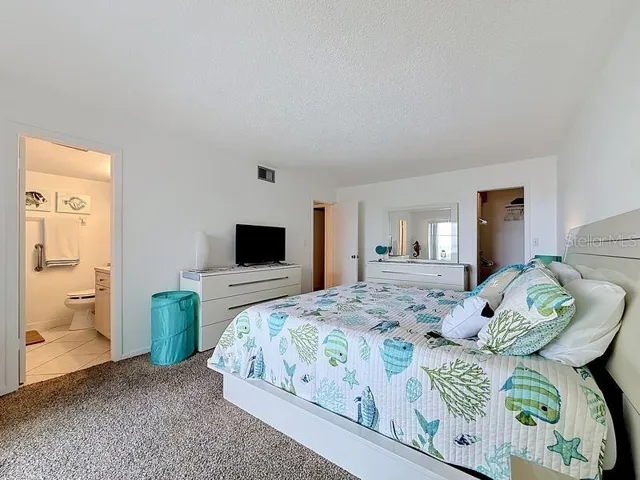Peaceful Primary Suite with an abundance of natural light, soothing coastal tones, and space to unwind after a long day