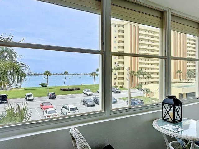 Versatile Florida Room with bright natural light, beautiful intercoastal views, and sliding glass doors- perfect for relaxing or working from home.