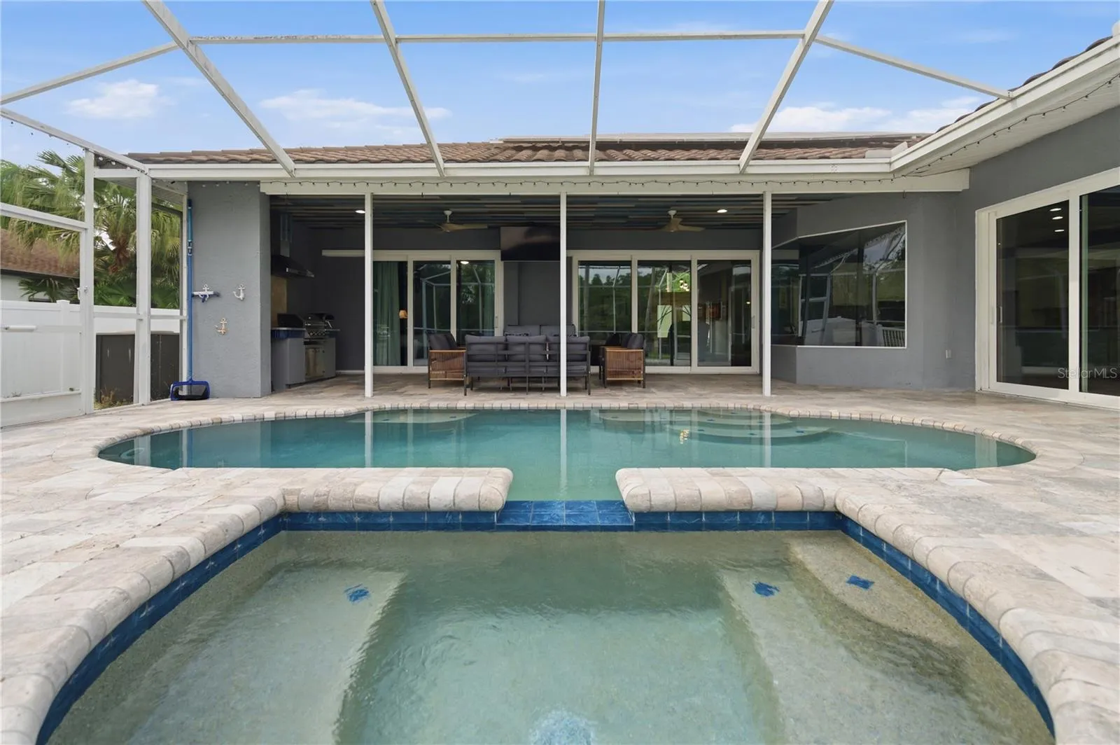 View from the Spa of the Covered Pool Patio and Outdoor Kitchen