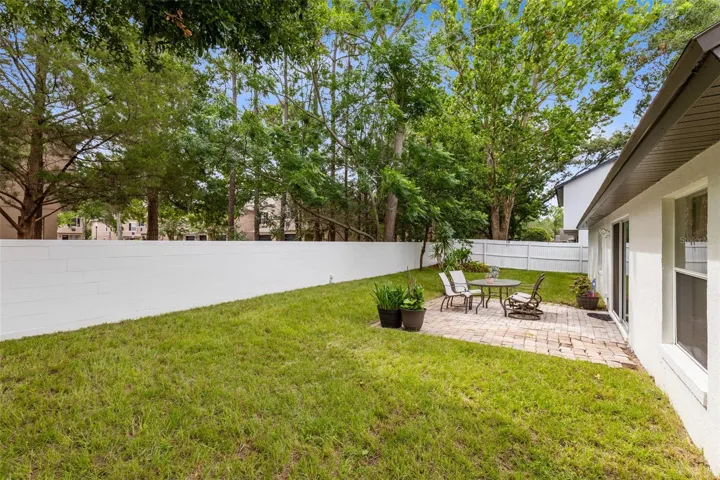 Partially fenced backyard.  Sides are fenced, wall in back.