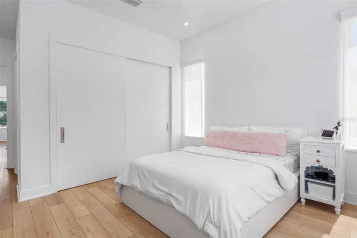 Bedroom 4 boats en-suite bath with glass-enclosed shower, closest system, window treatment, dimmable lights, and Minka ceiling fan, known for their quiet operation and distinctive style
