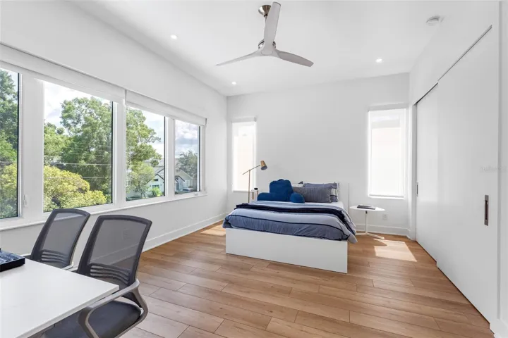 Bedroom 3 boats en-suite bath with glass-enclosed shower, closest system, window treatment, dimmable lights, and Minka ceiling fan, known for their quiet operation and distinctive style