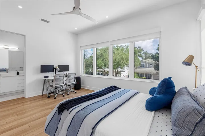 Bedroom 3 boats en-suite bath with glass-enclosed shower, closest system, window treatment, dimmable lights, and Minka ceiling fan, known for their quiet operation and distinctive style