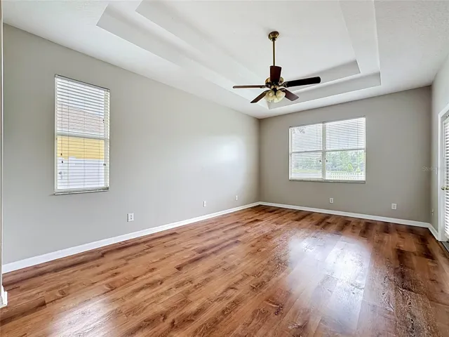 Primary bedroom is 12x21 and is capped off with a tray ceiling.  Your California king size bed will definitely fit