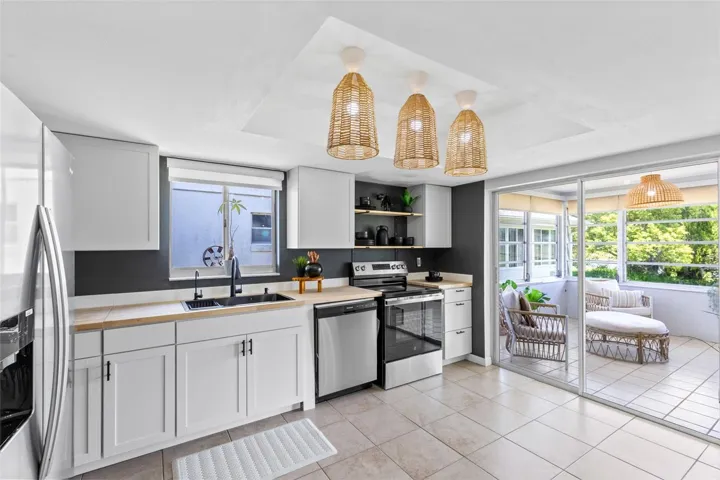 Brand NEW Kitchen offers modern look accented by warm light fixtures and butcher block counter.