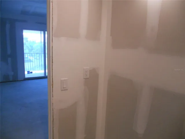 PRIMARY BATHROOM VANITY AREA. SLIDING DOOR TO BALCONY.