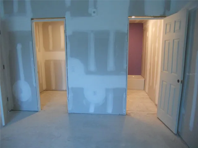PRIMARY BEDROOM. WALK-IN CLOSET ON LEFT. BATHROOM ON THE RIGHT.