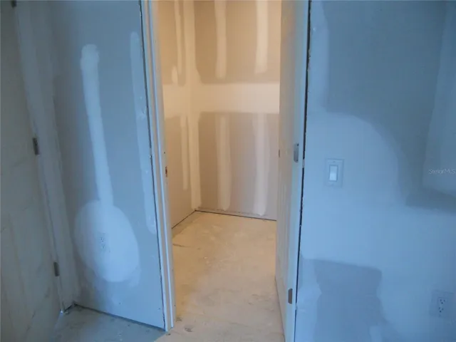PRIMARY BEDROOM WALK-IN CLOSET.
