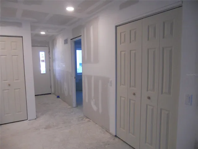 FOYER AREA. KITCHEN PANTRY CLOSET ON LEFT. BEDROOM 2 ENTRY ON RIGHT. LIVING ROOM CLOSET ON RIGHT.