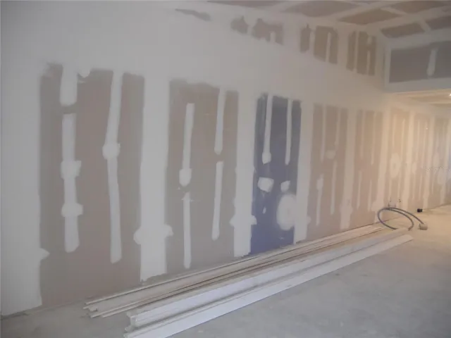 LIVING ROOM, NEW DRY WALL AND TRIM FOR BASE BOARDS AND DOORWAYS.