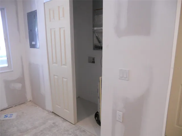 LAUNDRY/HVAC CLOSET HAS TILE FLOOR AND SLIDER TYPE DOORS.