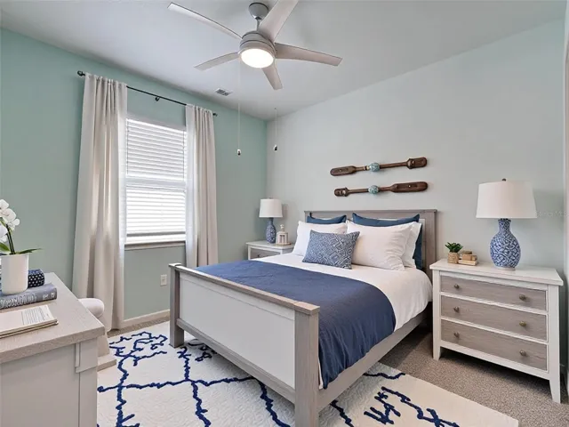 3rd bedroom with en suite bath, ceiling fan, new carpet, custom paint and virtual decor.