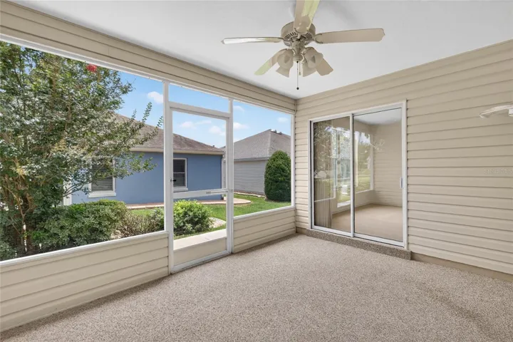 Enclosed lanai featuring beautiful Chattahoochee River Rock flooring and a paddle fan, creating a comfortable space to relax and enjoy Florida's year-round weather.